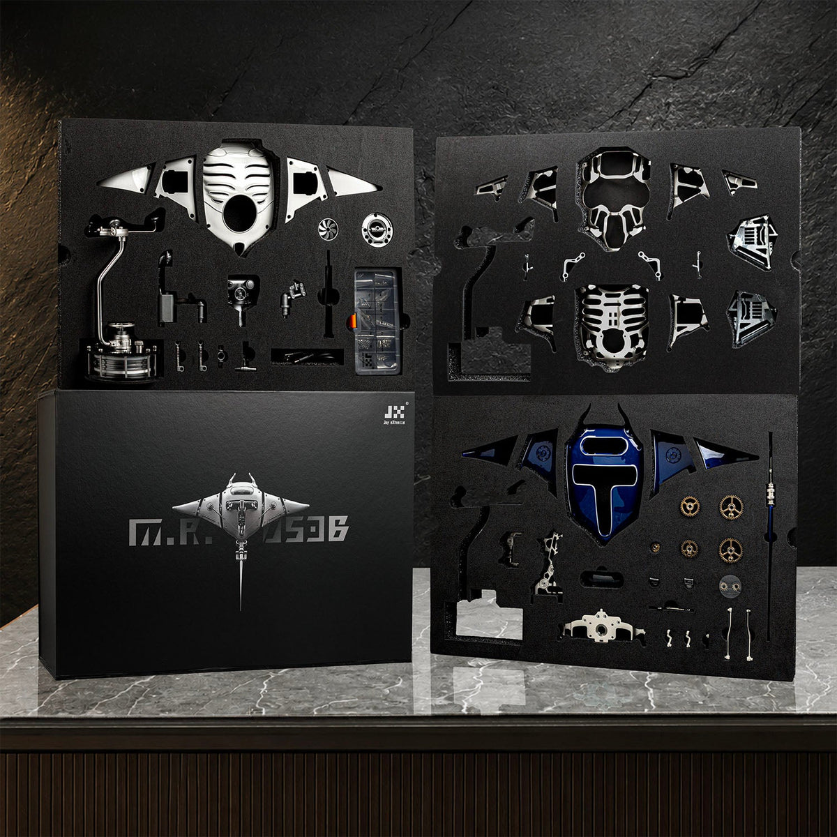 Mecha Ray Blue — the assembly kit laid out as cut component sheets with tools and fixings, kinetic metal sculpture by IFL Watches.
