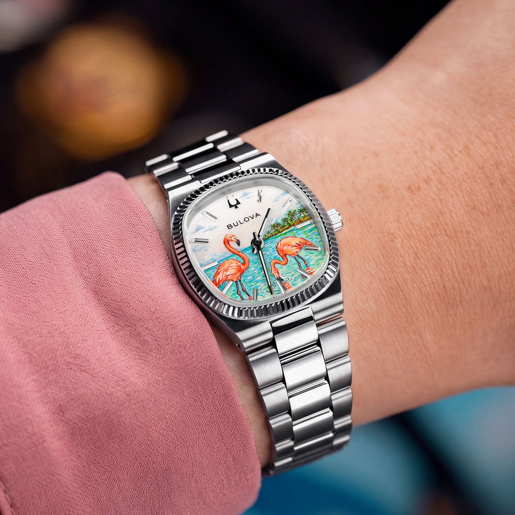 Bulova Super Seville Mini Havana — Custom hand-painted dial seen at the wrist, one flamingo dipping its beak among ripples between silver baton markers, a bespoke timepiece by IFL Watches.
