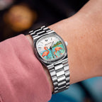 Bulova Super Seville Mini Havana — Custom hand-painted dial seen at the wrist, one flamingo dipping its beak among ripples between silver baton markers, a bespoke timepiece by IFL Watches.
