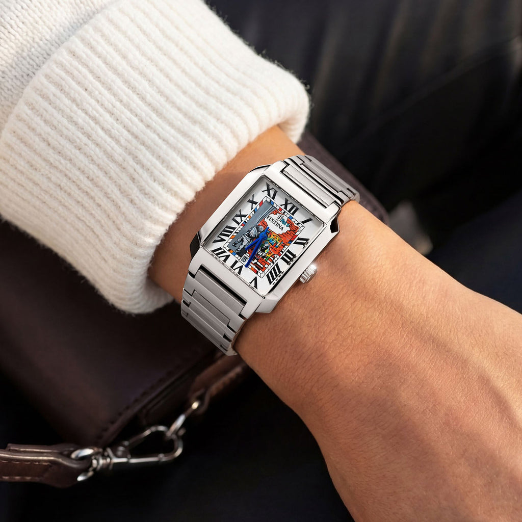 Festina Freedom 29 mm on wrist — hand-painted street-art dial featuring graffiti lettering and stencil figures on a rectangular stainless-steel case with integrated bracelet. Limited edition by IFL Watches.