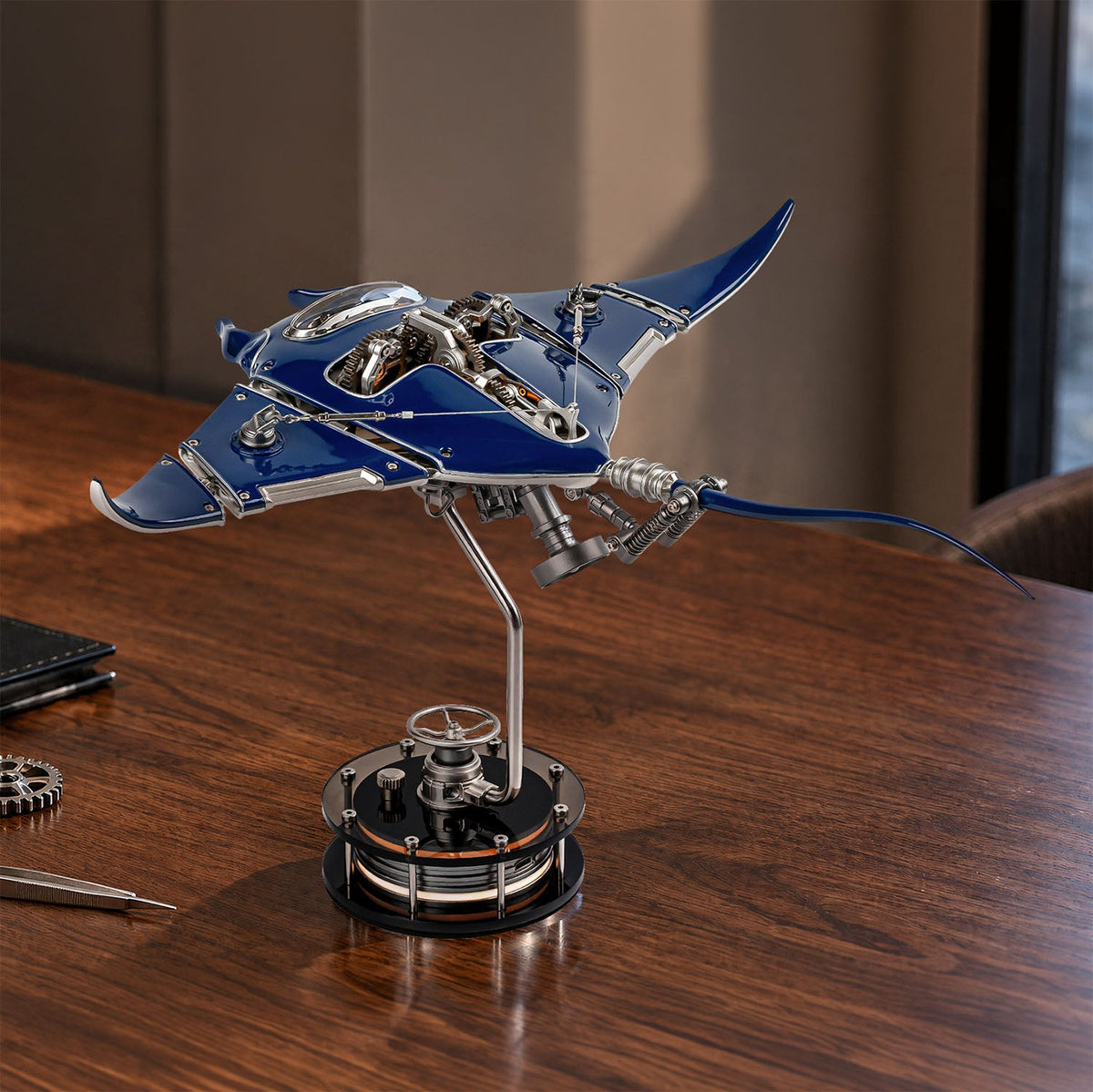 Mecha Ray Blue — resting on a walnut desk in warm afternoon light, kinetic metal sculpture by IFL Watches.