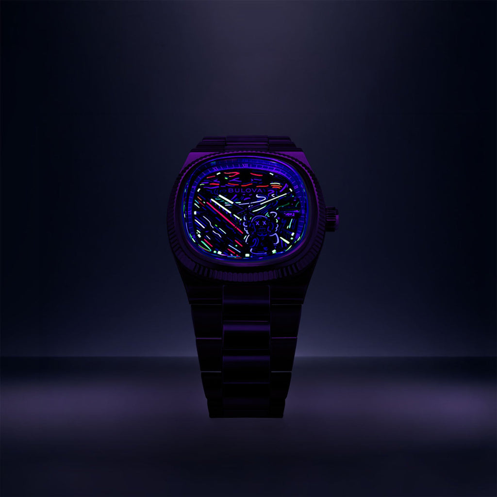 Bulova Super Seville Scream — Standing upright in a darkened studio under UV light, the neon strokes and the figure's outline glowing across the dial, limited edition timepiece by IFL Watches