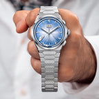 Lucky Harvey Chiming Watch 2.0 Blue — Held in hand, showing the blue dial and big date, available at IFL Watches.