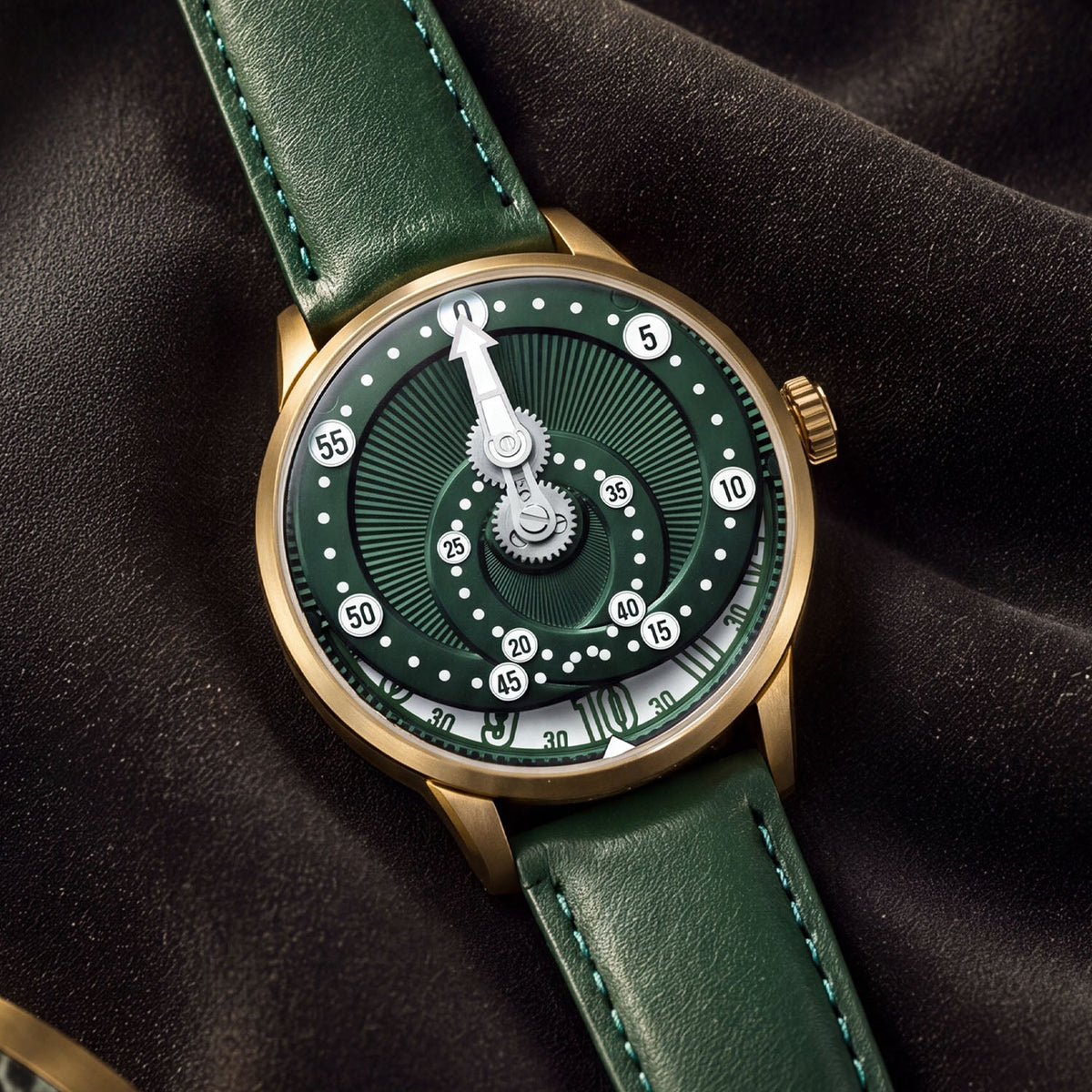 Mandetbrote Orbital Bronze Crush — Resting on dark fabric, showing the bronze case and crown, available at IFL Watches.