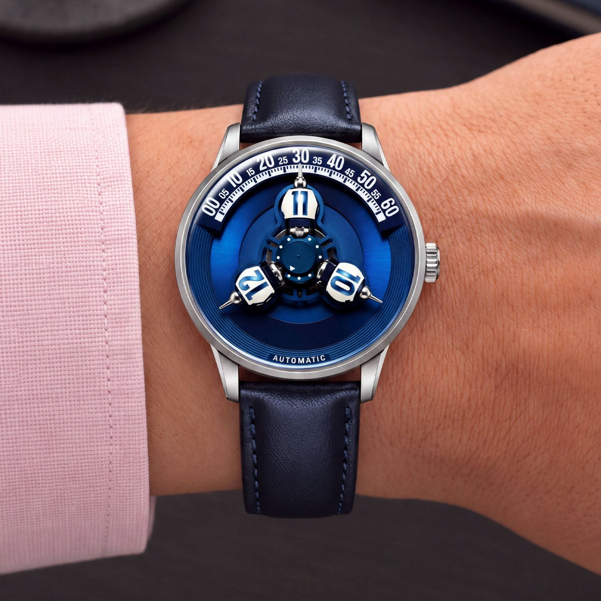 Vortichron Timeorb Blue — Worn on wrist with a pink shirt cuff, showing the hour spheres beneath the minute arc, available at IFL Watches.