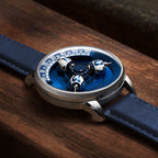 Vortichron Timeorb Blue — Low side view on wood, showing the case profile and raised spheres under sapphire crystal, available at IFL Watches.