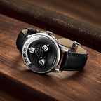 Vortichron Timeorb Midnight Black — Lying on a wooden surface, showing the black leather strap and folding clasp, available at IFL Watches.