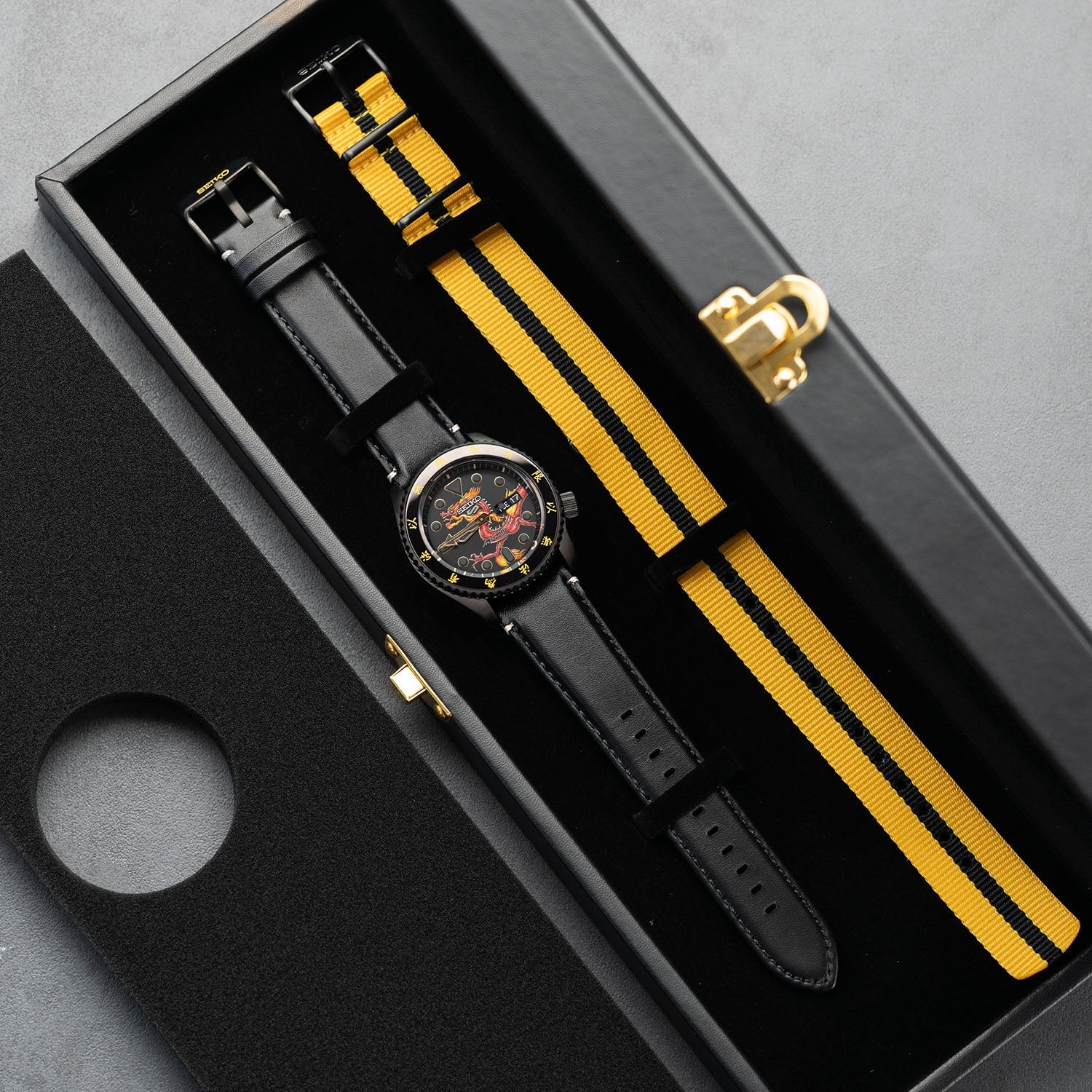 Custom Seiko 5 Sports 55th Anniversary Bruce Lee Limited Edition watch featuring hand-painted dragon design by IFL Watches, bespoke timepiece with black leather and yellow nylon straps.